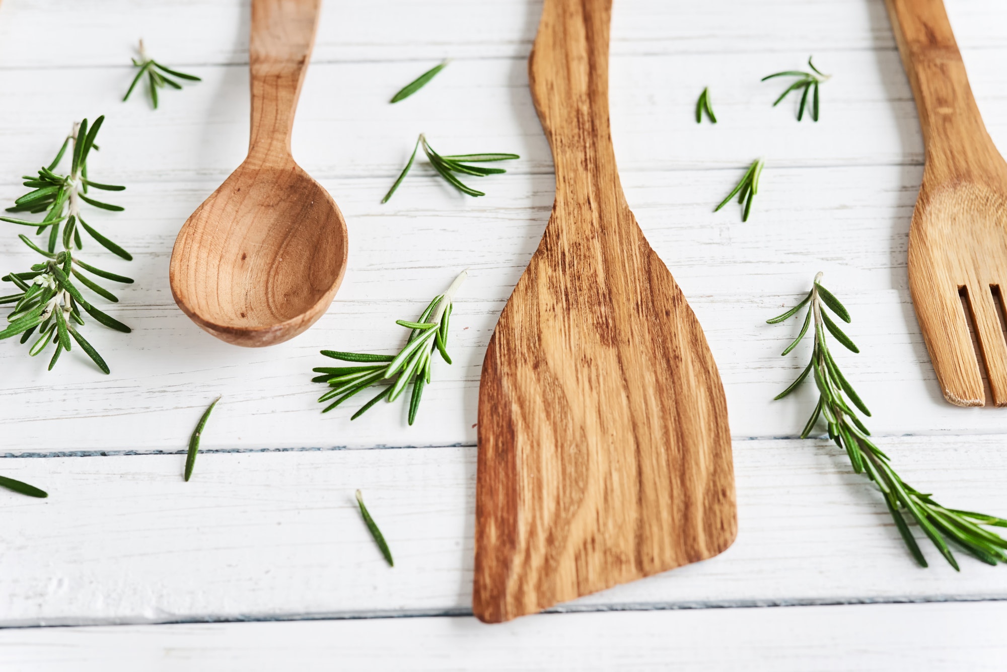 wooden cutlery, spatula and spoon on white wooden table